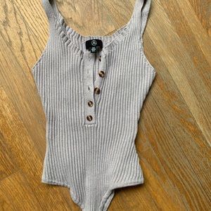 Ribbed tan bodysuit with brown buttons